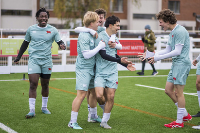The Men's 1s football team celebrating a goal at Grange Road Stadium