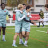 The Men's 1s football team celebrating a goal at Grange Road Stadium
