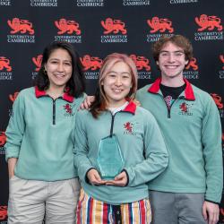 Sports Award winners holding their trophy in front of the red lion
