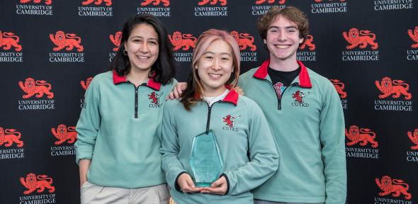Sports Award winners holding their trophy in front of the red lion